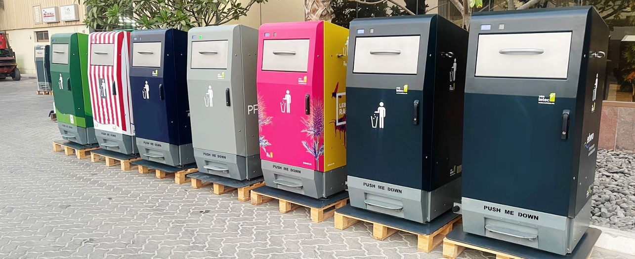Colorful outdoor smart trash bins are lined up on pallets