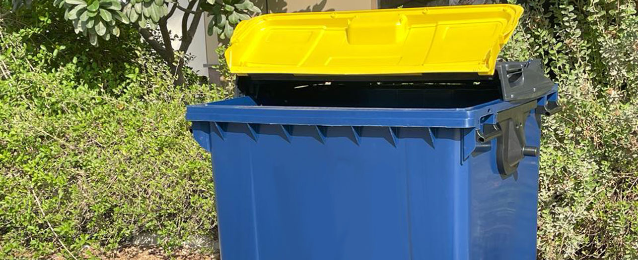 Blue outdoor recycling bin with yellow lid and printed waste symbols