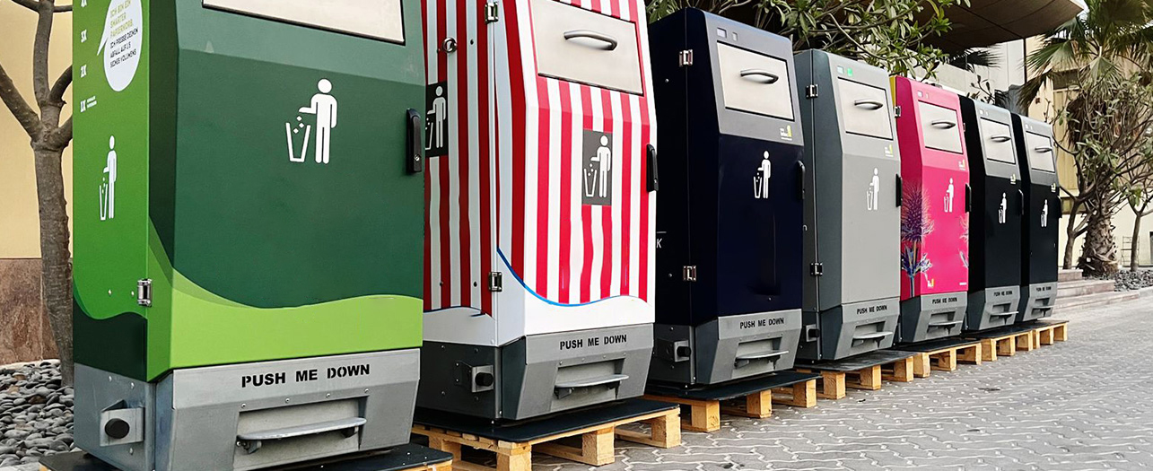 Colorful smart bins placed on wooden pallets in outdoors