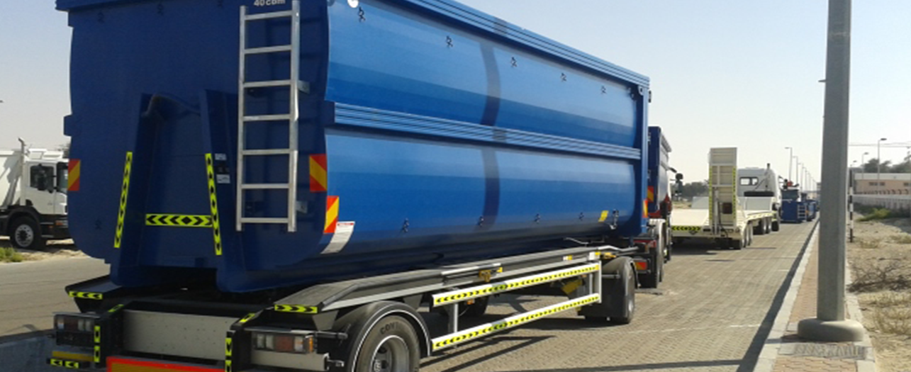 Blue waste transport container on truck