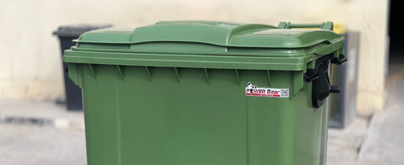 Green wheeled garbage bin for municipal waste collection
