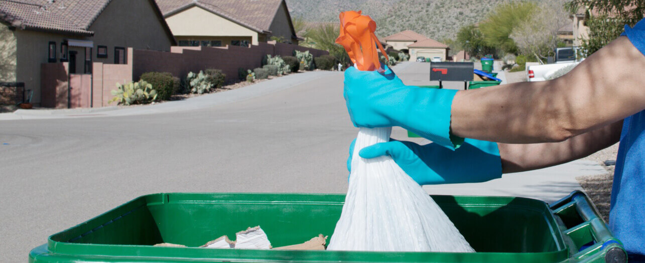 Man putting garbage in the garbage bin