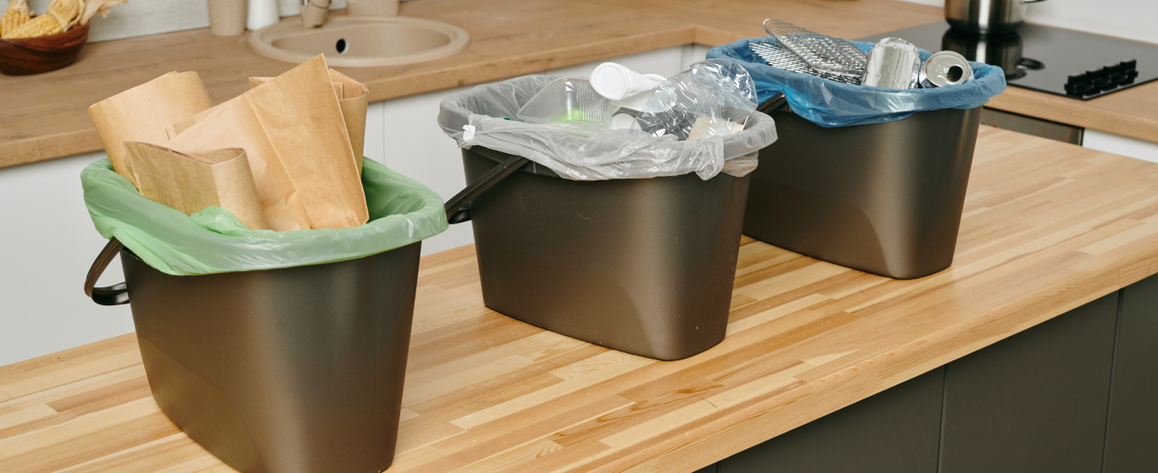 three garbage bins with sorted waste