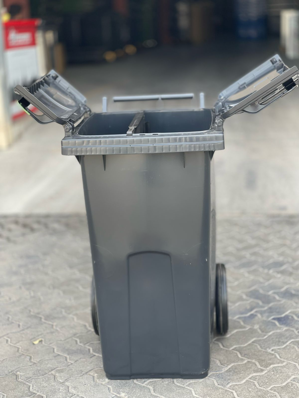 Green outdoor recycling compactor bin