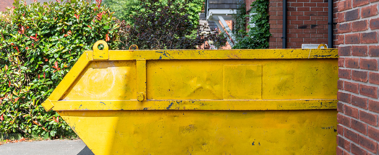 Yellow waste skip by Power Bear